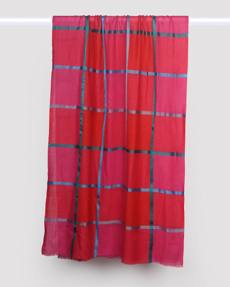 Red and pink plaid fabric draped over a white