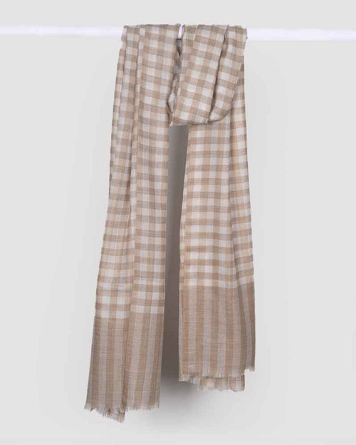 A cream-colored pashmina wool natural check stole