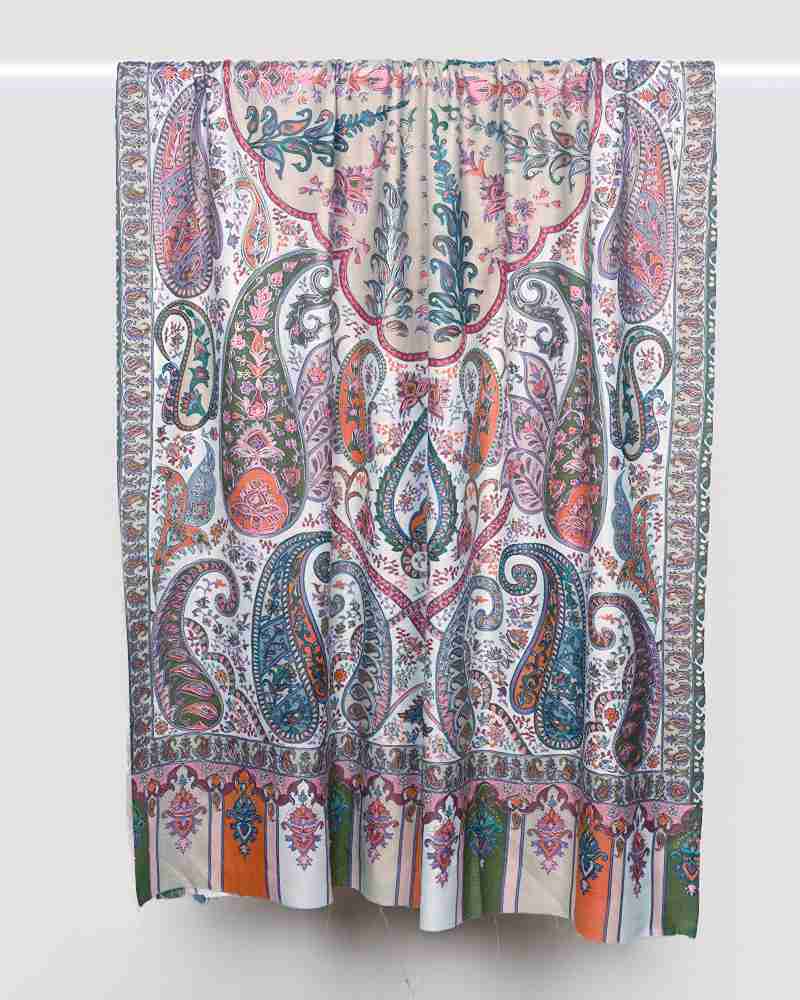 A pink pashmina wool shawl with intricate Kalamkari embroidery displayed.