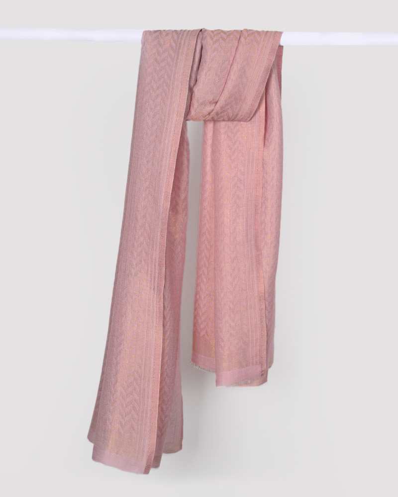 A pink pashmina wool stole with zari chevron pattern hanging against a white background.

